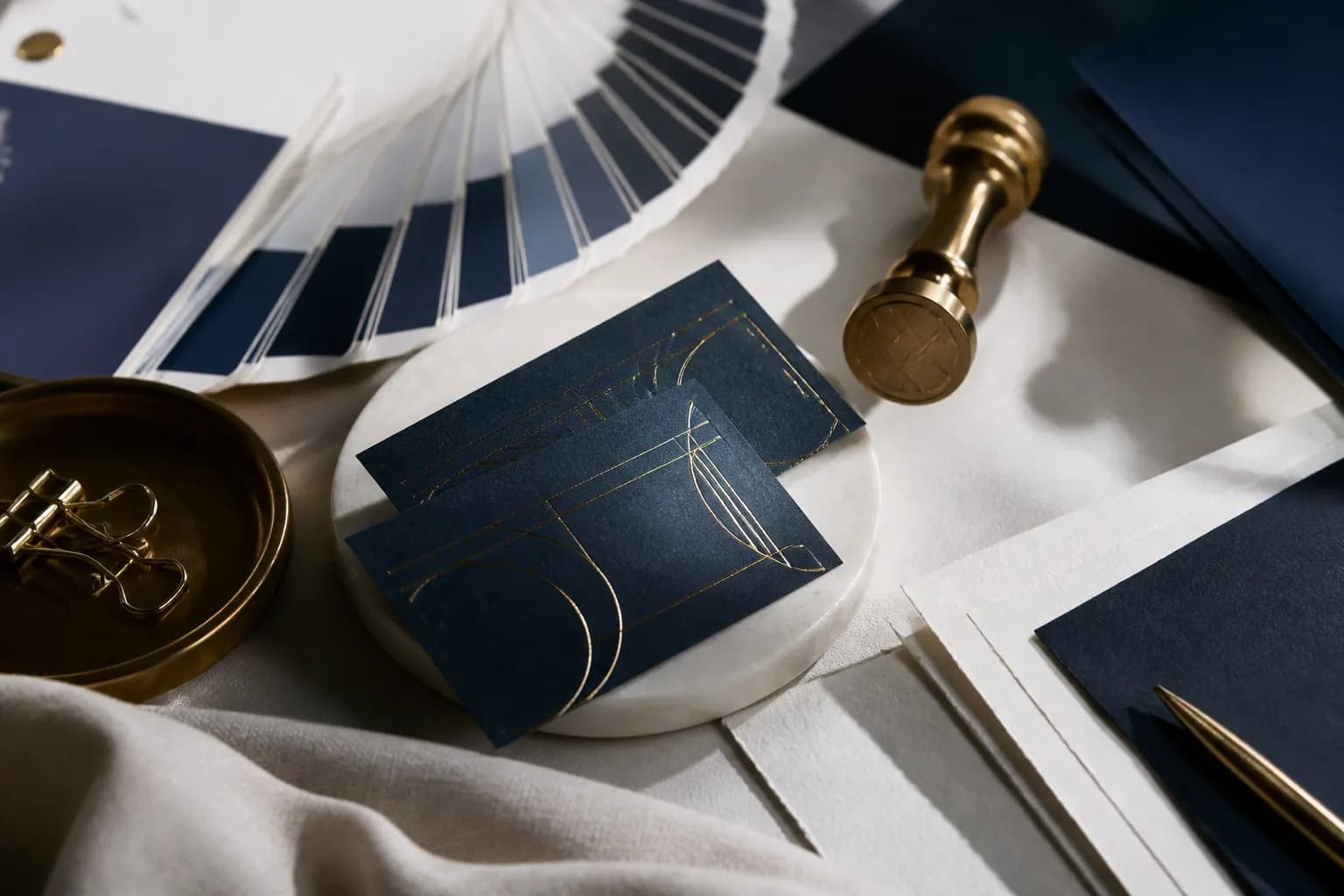 Foil-stamped stationery, colour swatches, and a metal stamp